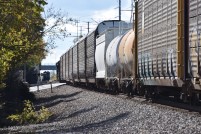 Blocking both the Spurr Road and Greendale Road crossings, NS 7665 approaches a red signal at Control Point Greendale, held up by heavy traffic further south, while a northbound waits for clearance